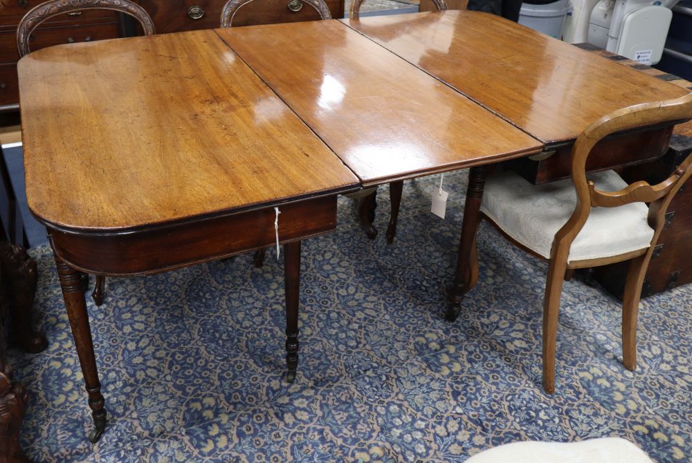 A Regency mahogany D-end extending dining table, L.163cm extended (one spare leaf) W.112cm, H.73cm